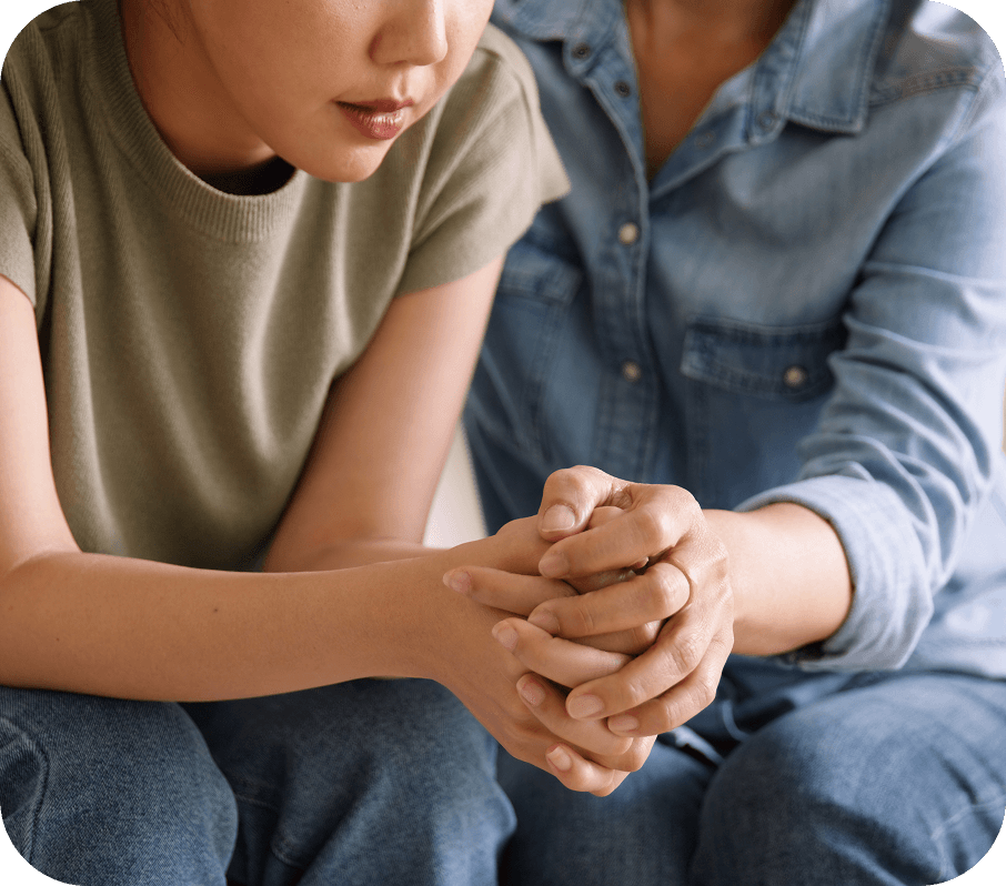 An adult comforting a young person.