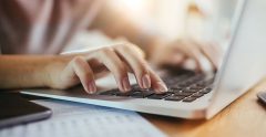 Close up of a woman using a laptop