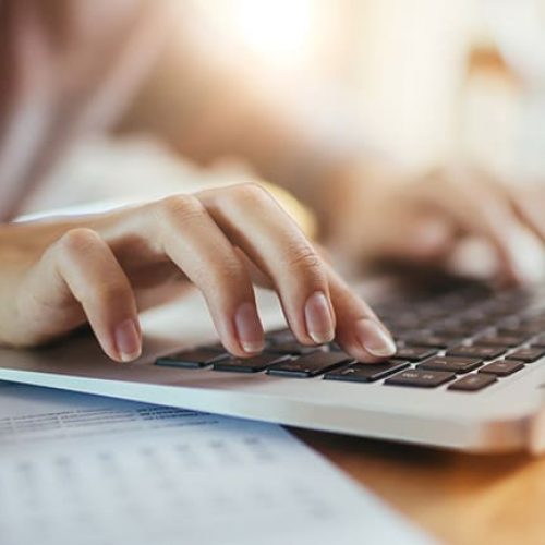 Close up of a woman using a laptop